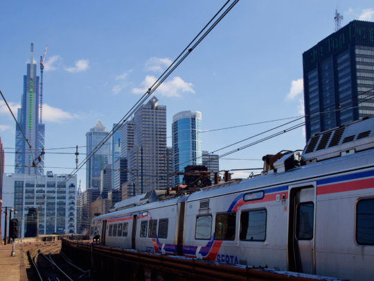 A SEPTA Regional Rail train beneath the Philadelphia skyline
